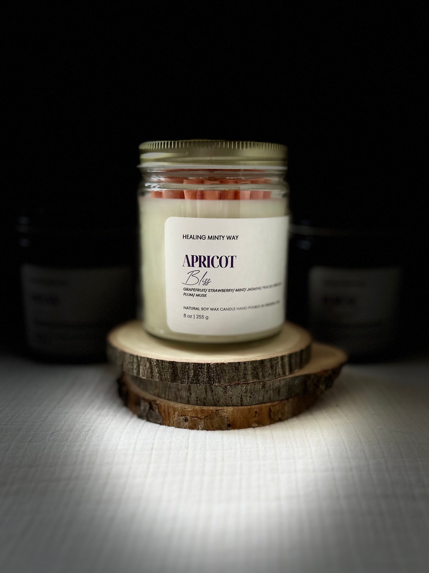 Hand-poured Apricot Bliss Soy Wax Candle with notes of apricot, jasmine, and musk