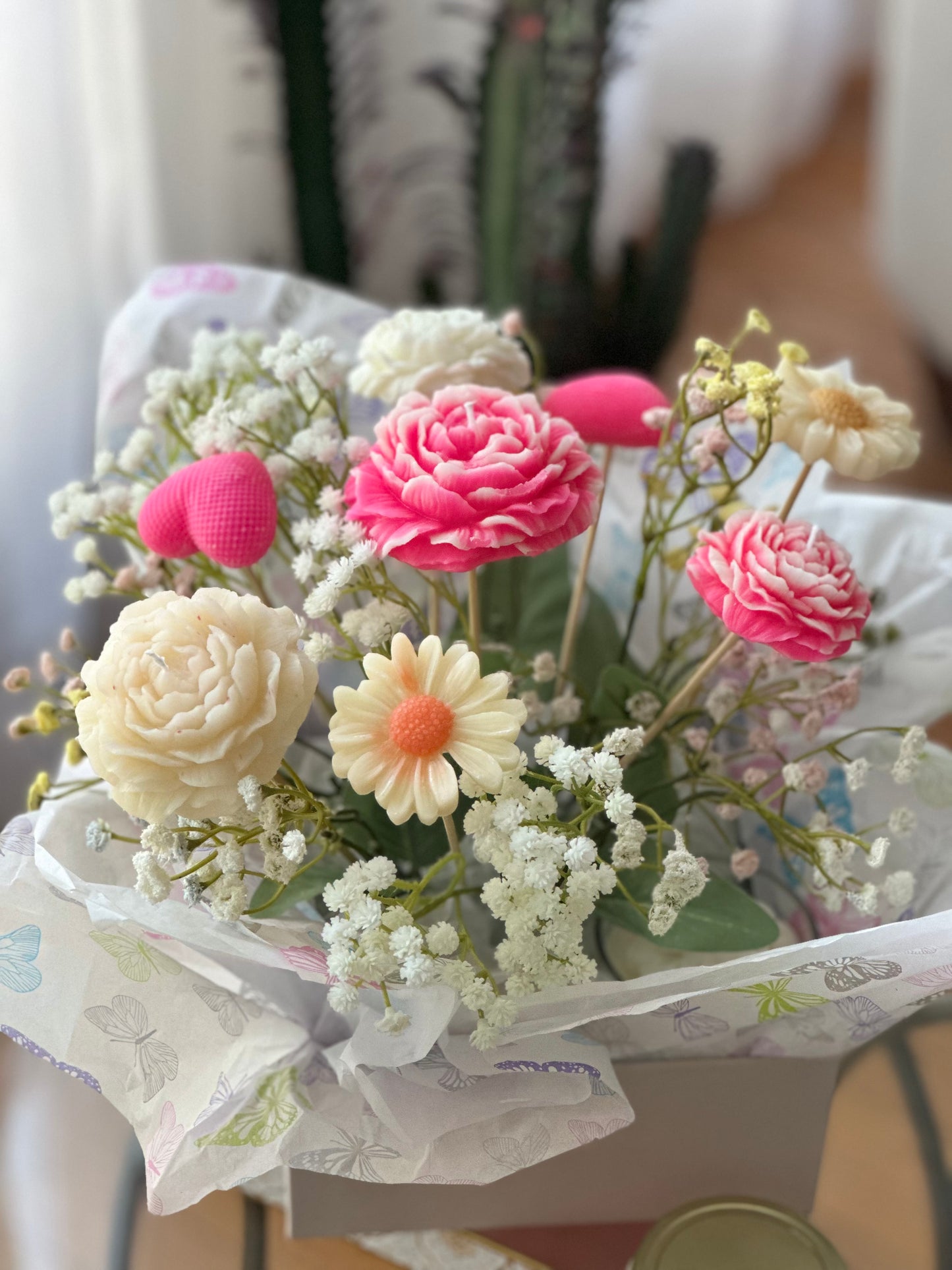 Custom candle flower arrangement featuring handcrafted candles with floral accents, perfect for events and special occasions.